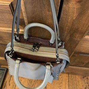 Coach 1941 Rogue 25 Bag, gray pebbled leather with burgundy suede interior.